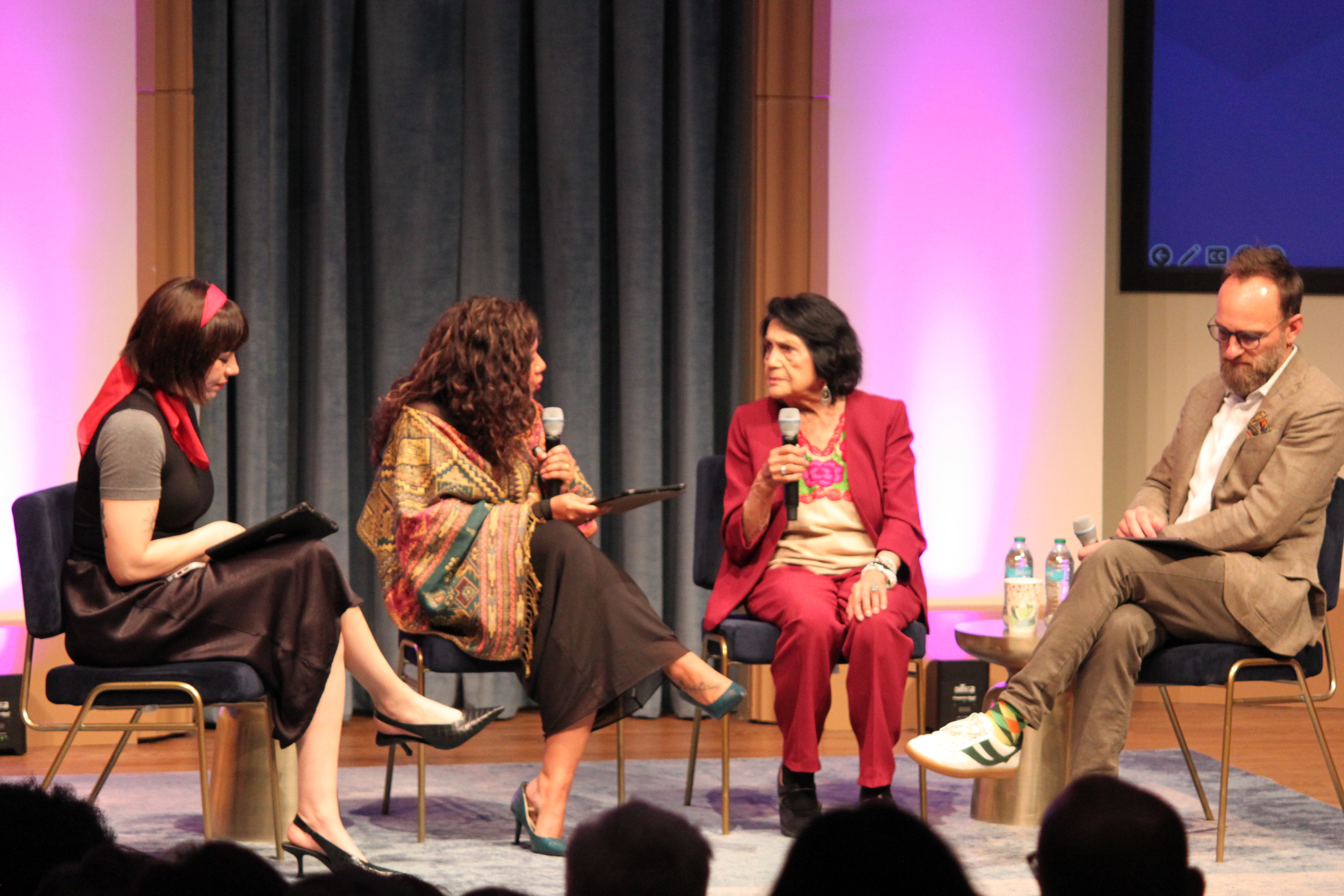 Dolores Huerta onstage with Q&A session moderators