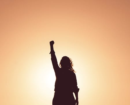 Woman with arm raised in the air